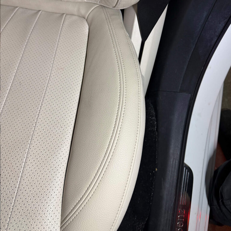 Light beige car leather seat side bolster after repair and refinishing