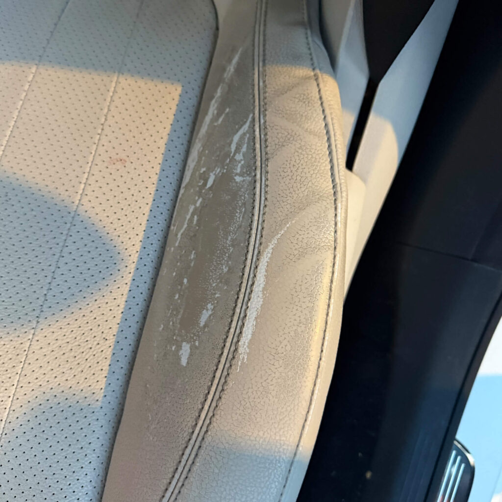 Worn light beige car leather seat side bolster before repair